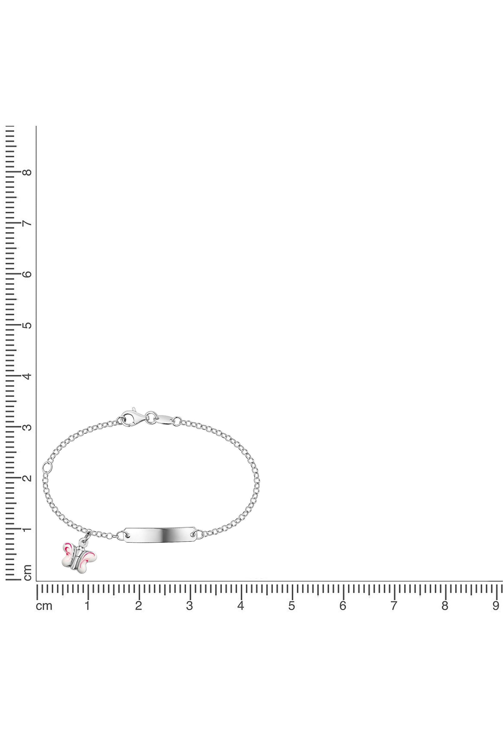 Silbernes Scout Armband mit rosa Schmetterling neben einem Lineal zur Größendarstellung